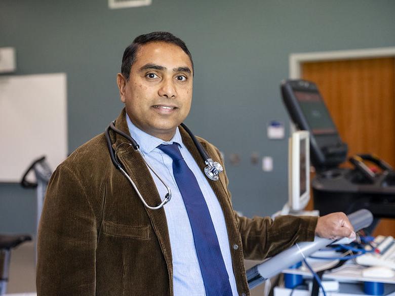 Faculty member poses for photo in kinesiology classroom